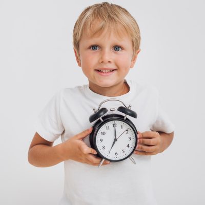 little-boy-holding-clock-min